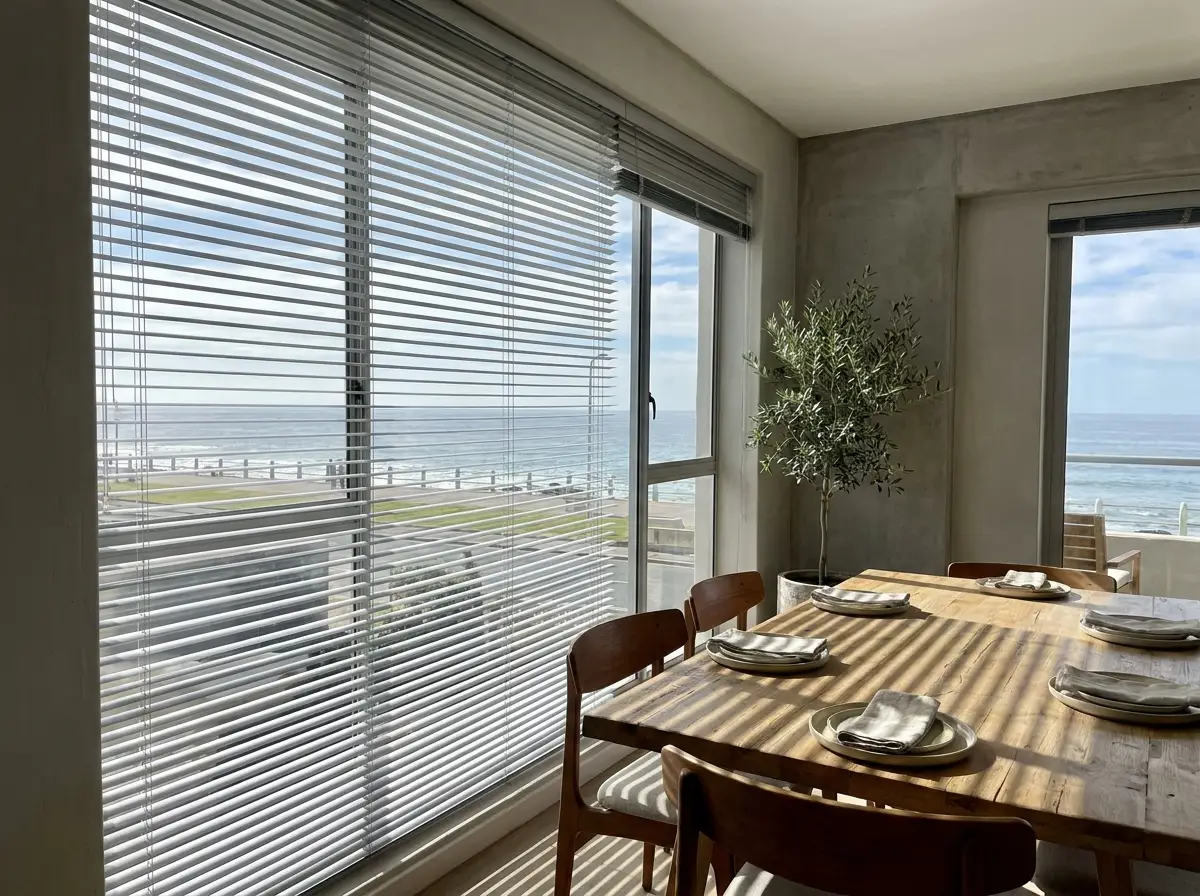 Aluminium venetian blind slats casting fine striped light across a dining table